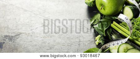 Fresh healthy vegetables, water and measuring tape. Health, sport and diet concept