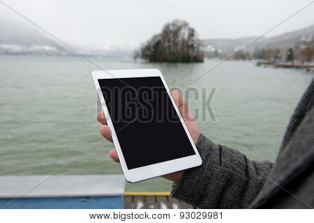 Digital tablet with isolated screen in male hands.