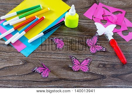 The Child Makes Decoration Paper Paper Butterfly In A Glass. Child Paints Paper Part Of The Product.