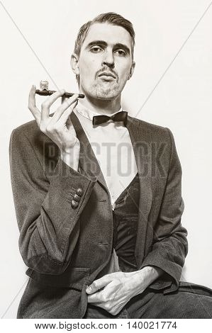 Retro portrait of an adult man smoking a pipe closeup