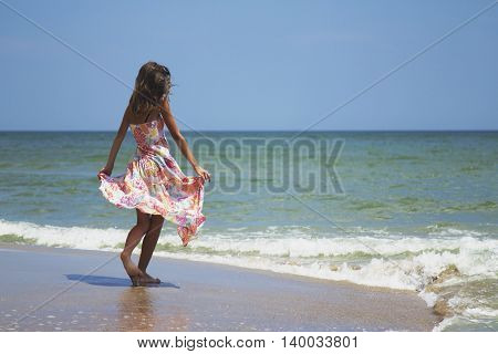 happy and beautiful young woman on sea coast (stylization birth goddess of love Aphrodite)
