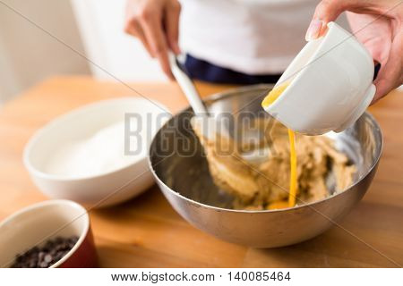 Adding egg inside the dough for making cookies