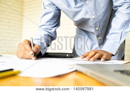 architect drawing architectural project on blueprint engineering concept architecture concept soft focus vintage tone