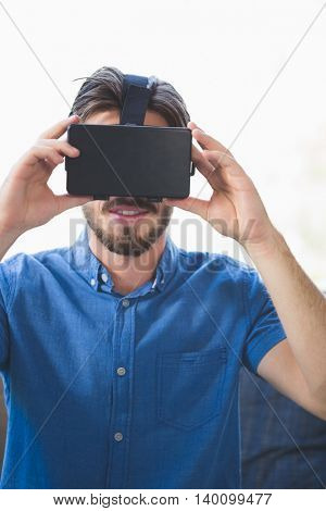 Close-up of man using virtual reality glasses at home