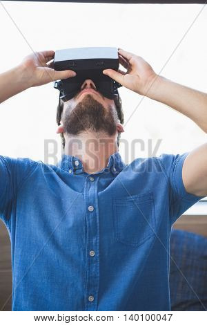 Close-up of man using virtual reality glasses at home