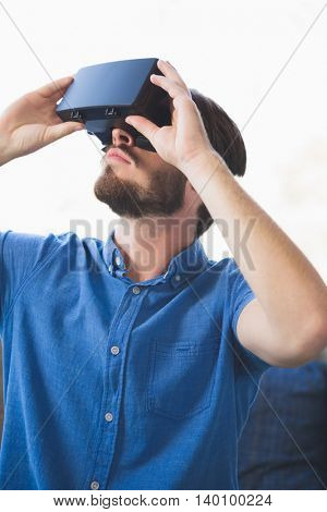 Close-up of man using virtual reality glasses at home