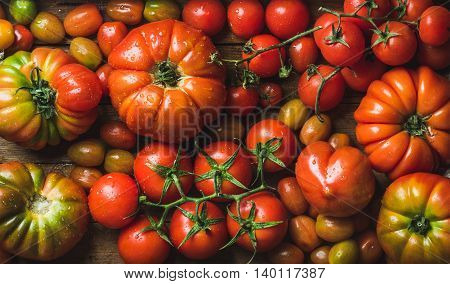 Colorful tomatoes of different sizes and kinds, top view, horizontal composition