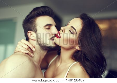 Sexy passionate couple foreplay at home red lips closed eyes