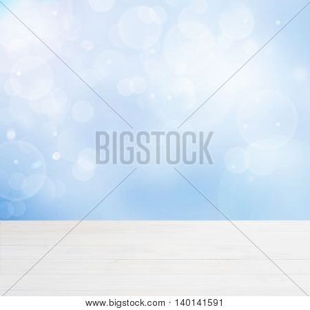 White wooden board empty table in abstract blue background with bokeh. Perspective white wood board over blurred blue background - mockup for display of product