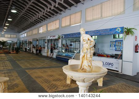 ESTEPONA, SPAIN - JULY 18, 2008 - Ornamental fountain and stalls inside the indoor market (Mercado municipal de Abastos) Estepona Malaga Province Andalucia Spain Western Europe, July 18, 2008.
