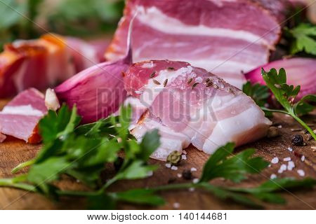 Bacon. Smoked bacon parsley herb salt pepper and garlic.Stll life studio shot.