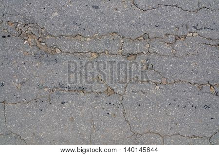 Macro closeup on concrete asphalt cracks on the road