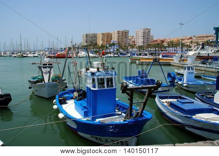 ESTEPONA, SPAIN - JULY 18, 2008 - Traditional fishing boats in the harbour with yachts and the marina to the rear Estepona Malaga Province Andalusia Spain Western Europe, July 18, 2008.