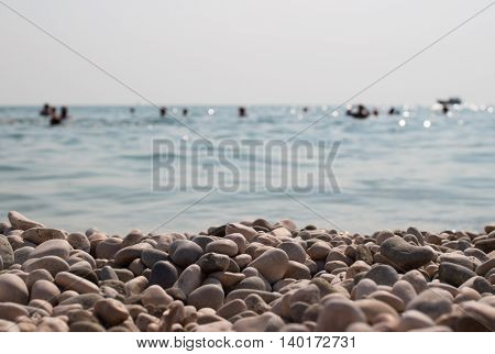 Rocks on the coast of sea. People bathe