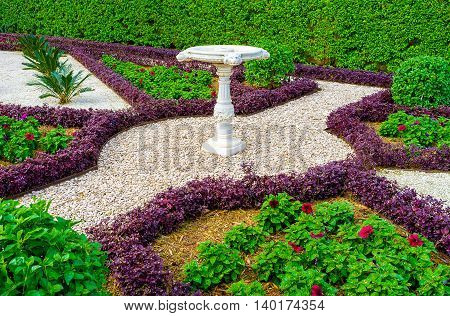 The footpaths in Bahai gardens fenced with different plant borders and covered with gravel make nice ornaments on earth Haifa Israel.