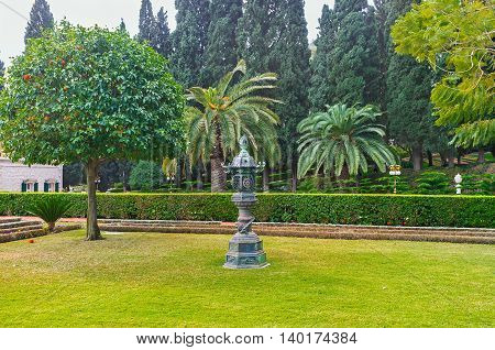 The meadow in Bahai Garden decorated with the Oriental style urn Haifa Israel.