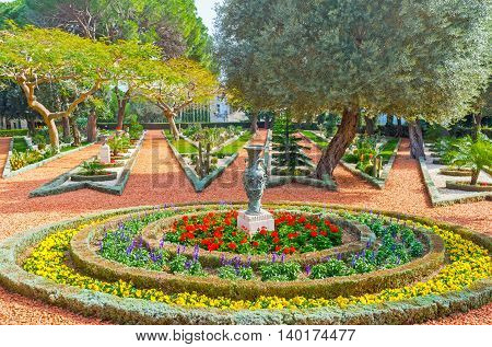 The gravel paths diverge like the rays of a star separated with the colorful flower beds Bahai Gardens Haifa Israel.