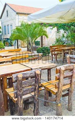 The rustic restaurant with the timbered furniture in the summer terrace Haifa Israel.