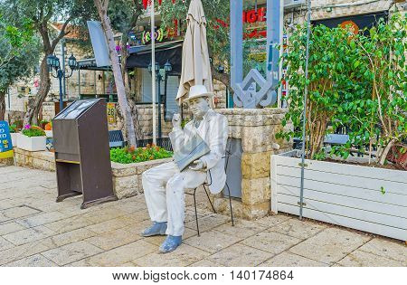 HAIFA ISRAEL - FEBRUARY 20 2016: The white mannequin with a menu advertises the restaurant of local cuisine located in German Colony on February 20 in Haifa.