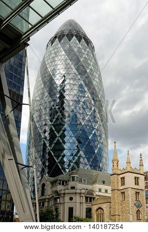 LONDON UK - JULY 1 2014: The modern 30 St Mary Axe called Swiss Re Building or informally the Gherkin in the City of London one of the leading centers of global finance.
