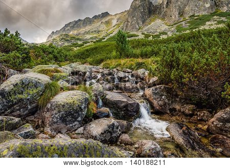 Mountain Landscape with a Creek and Rocks in Foreground on Cloudy Day. Mlynicka Valley High Tatra Slovakia.