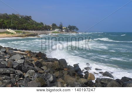 beautiful tropical beach with strong wave and building on the shore in muine vietnam