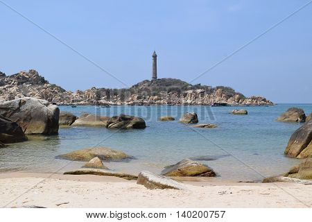 beautiful tropical beach with many rocks and historic lighthouse on small island in ke ga near muine vietnam