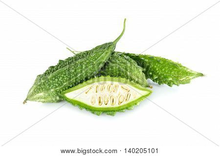 whole and half cut fresh bitter gourd on white background