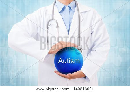 Doctor holding blue crystal ball with autism sign on medical background.