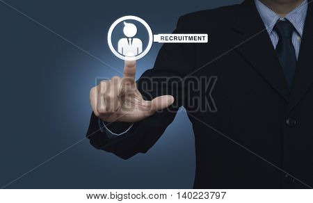 Hand pressing businessman with magnifying glass icon over blue background Recruitment concept