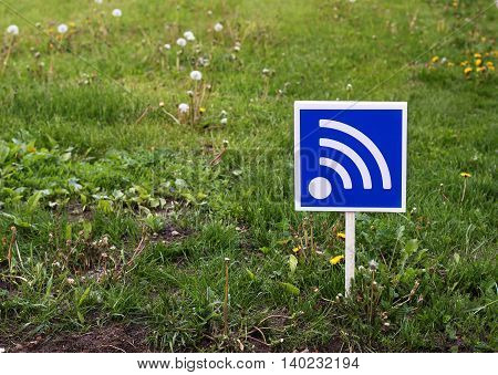 RSS sign on a green lawn. Free wifi simbol