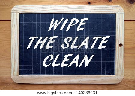 The words Wipe The Slate Clean in  white text on a blackboard meaning you intend to make a fresh start