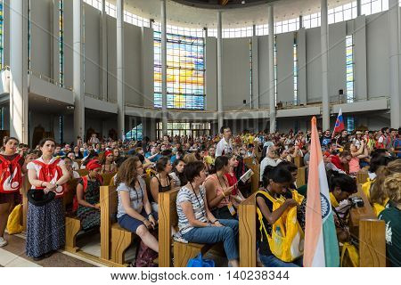 CRACOW POLAND - JULY 26 2016: World Youth Day 2016 - Crowd of Pilgrims inside of the Sanctuary of Divine Mercy in Lagiewniki. Cracow Poland