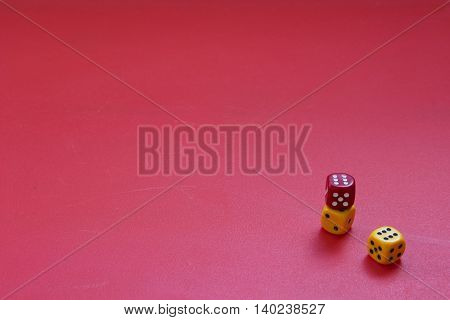 Dices on a matte red background. Concept of luck gambling or chance. Three color dices.
