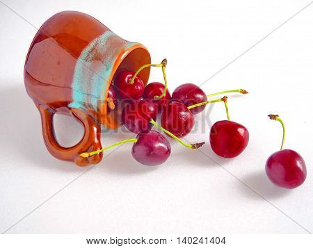 Fresh Cherries in a Cup Lying on White Table