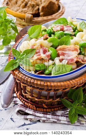 Pasta with bacon and vegetables in portion plate. Selective focus.