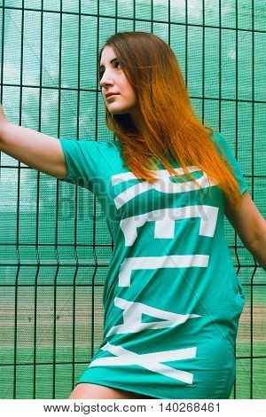 Model posing near the lattice. Summer shoot