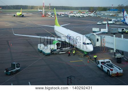 MOSCOW, RUSSIA - APRIL 30, 2016: Loading of Luggage in the Boeing 737 (VQ-BKW ) airlines S7 Siberia Airlines at Domodedovo airport