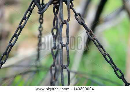 Old black rusty iron chains closeu. Shallow depth of field.
