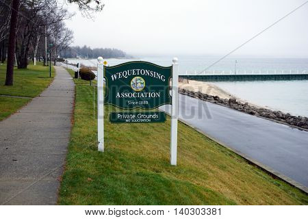WEQUETONSING, MICHIGAN / UNITED STATES - DECEMBER 22, 2015: A sign indicates that soliciting is prohibited on the private grounds of the Wequetonsing Association.