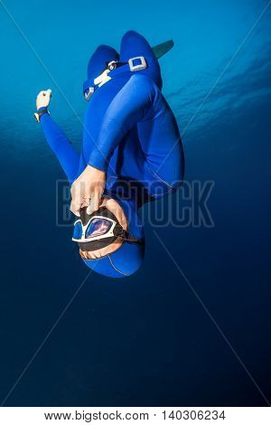 Freediver descending with monofin. Free immersion discipline