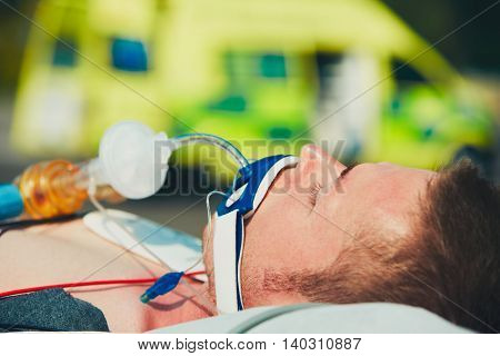 Paramedic preparing the patient after resuscitation for transport to the hospital.