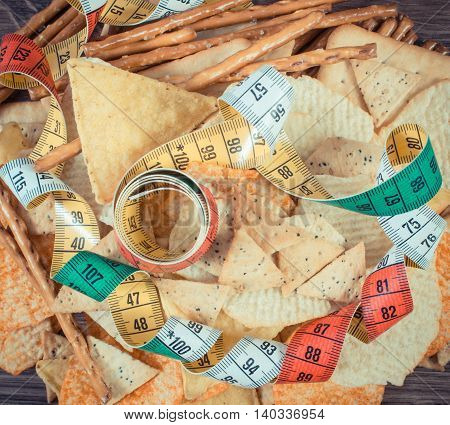 Vintage Photo, Centimeter With Salted Crisps, Cookies And Breadsticks, Unhealthy Food And Slimming