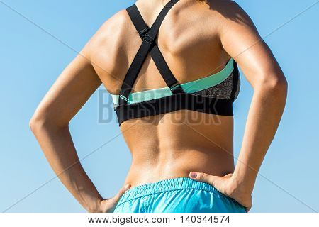 Macro close up female spine outdoors. Body part of young girl in sportswear outdoors.