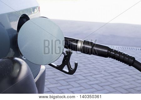 car fill with gasoline at a gas station.