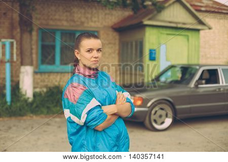 The girl in the nineties. On the background of old car