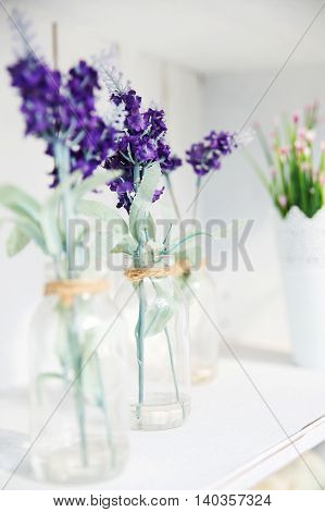 beautiful purple flowers in the glass bottle