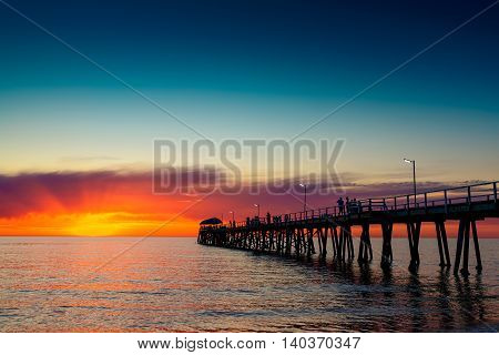 People relaxing on the Henley Beach Jetty at sunset South Australia
