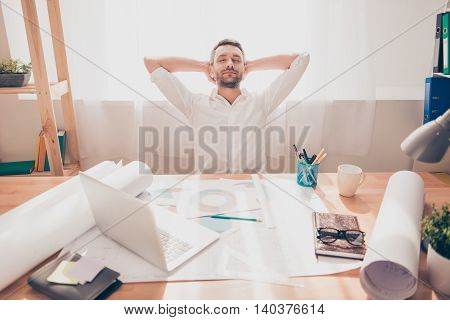 Tired Engineer Resting After End Of Long Working Day