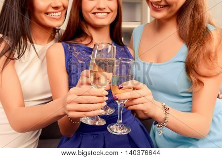 Close Up Of Three Happy Smiling Women Holding Glasses With Shampagne